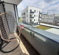 The balcony of a 2-room apartment on Slnečnicová Street in Rovinka with a swing and a view of the surroundings.