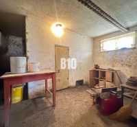 The basement of a family house with furniture and buckets on the table.