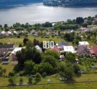Spacious gardens and family houses in Považská Bystrica with a view of the water surface.