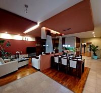 Living room and dining room in a family house with a wooden decor floor.