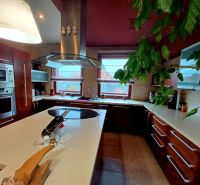 A kitchen in a family house with modern appliances and a central island.