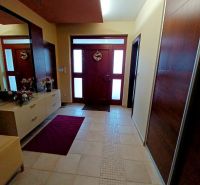 Entrance hall in a family house with tiles and a wardrobe, complemented by decorations.