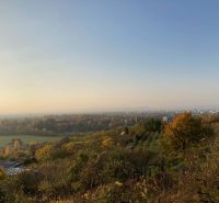Panorama of the autumn forest and fields with a view of the town of Banka.