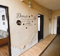A hallway in a family house with wall decorations and a wooden decor floor.