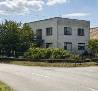 A family house on Jarná Street in the town of Novosad, surrounded by lush vegetation.