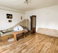 Living room in a family house with a sofa and wooden decor flooring.