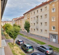 Študentská Street in Zvolen with apartment buildings and passing cars, suitable for a studio apartment.