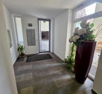 Entrance hall with flowers and mailboxes, bright space.