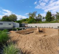 Construction site on Recreational Lands in Záhorce on Selešťany Street with greenery and a building.