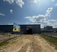 In Hniezdne, a building with a hall for a horse exhibition on a sunny day.