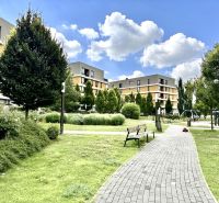 Residential complex with a park and playground on Bajkalská in Bratislava, Ružinov, surrounded by greenery.