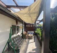 The terrace of a family house in Borský Mikuláš with a shelter and a garden swing.