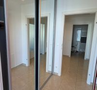 Built-in wardrobe with sliding mirror doors in a 3-room apartment.