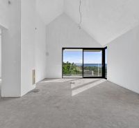 A spacious living room with large windows in a 5 or more room apartment and a view of nature.