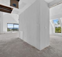 A spacious interior with large windows in a 5 or more room apartment.