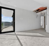 An interior with an unfinished floor and glass doors in a 5 or more room apartment.