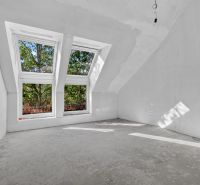 An attic room in a 5 or more room apartment with large skylights without flooring.