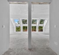A white interior with large skylights in a 5 or more room apartment.