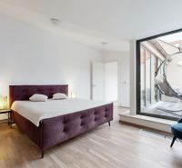 Bright bedroom in a 4-room apartment with a bed and a terrace, wooden decor flooring.
