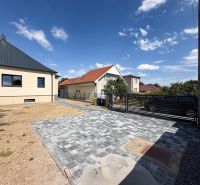 A family house on Trnavská Street in Nitra with a paved courtyard and blue sky.