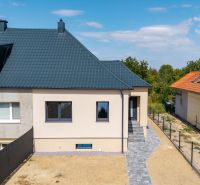 A family house on Trnavská Street in Nitra with a dark roof and a landscaped yard.