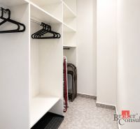 Storage space with hangers in a 2-room apartment and flooring with decor.