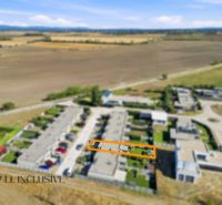 Aerial view of terraced family houses in Oľdza surrounded by fields.