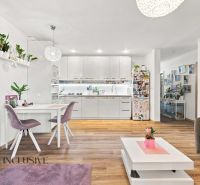 Interior of a family house with a kitchen, dining table, and floor with wooden decor.