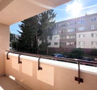 The balcony of a 3-room apartment on Švermova Street, Trenčín with a view of the surrounding building.
