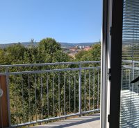 The view from a 2-room apartment in Pezinok on Mahulanka Street includes a balcony and trees.