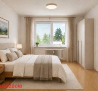 A bright bedroom with a bed, a cabinet, and a wooden decor floor in a 2-room apartment.