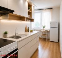 A kitchen in a 2-room apartment with a wood-patterned floor and a dining area.
