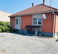 A family house on Sabinovská Street in Prešov, with an orange facade and a gravel yard.