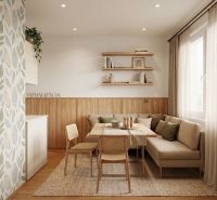 Living room in a two-room apartment with natural decorations and light wooden elements.