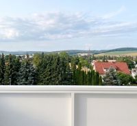 View of greenery and rooftops in Bánovce nad Bebravou from a 2-room apartment.