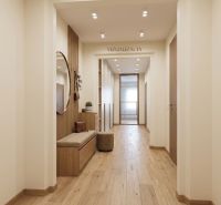 A hallway in a 2-room apartment with a wooden decor floor and a bench under a round mirror.