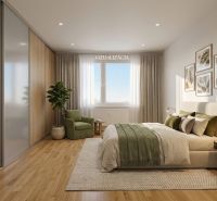 Bedroom in a 2-room apartment with wood-patterned flooring and a plant.
