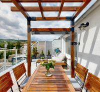 Terrace with wooden furniture and a view of the hills in Bratislava - Nové Mesto, Nobelova.