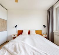 Bedroom in a 3-room apartment with a large bed, built-in wardrobe, and window.