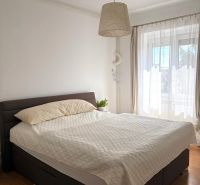 Bedroom in a 2-room apartment with a comfortable bed and a floor with a wooden decor.