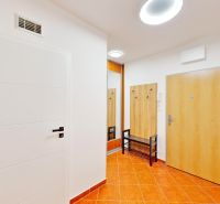 Entrance hall with tiles and furniture in a 2-room apartment.