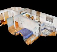3D model of a 2-room apartment with a wooden decor floor and an open living area.