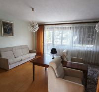 Living room in a family house with comfortable seating and a large window.