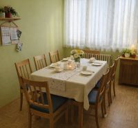 A dining room in a family house with a set table and a wooden decor floor.