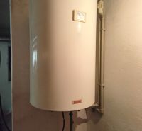 Wall-mounted hot water tank in a family house with very simple valves.