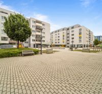 In Bratislava - Dúbravka at Pri Hrubej lúke, there is a square with apartments and benches.