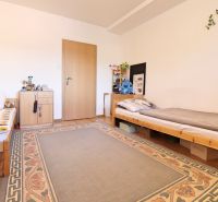 Children's room in a two-room apartment with two beds and a carpet on the floor with a wooden decor.