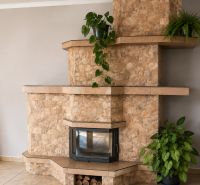 Stone fireplaces in a family house, decorated with plants, create a cozy atmosphere.