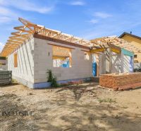 Construction of a family house in Marcelová in the stage of construction with a roof structure.