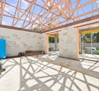 Construction of a family house in Marcelová with an unfinished roof structure.